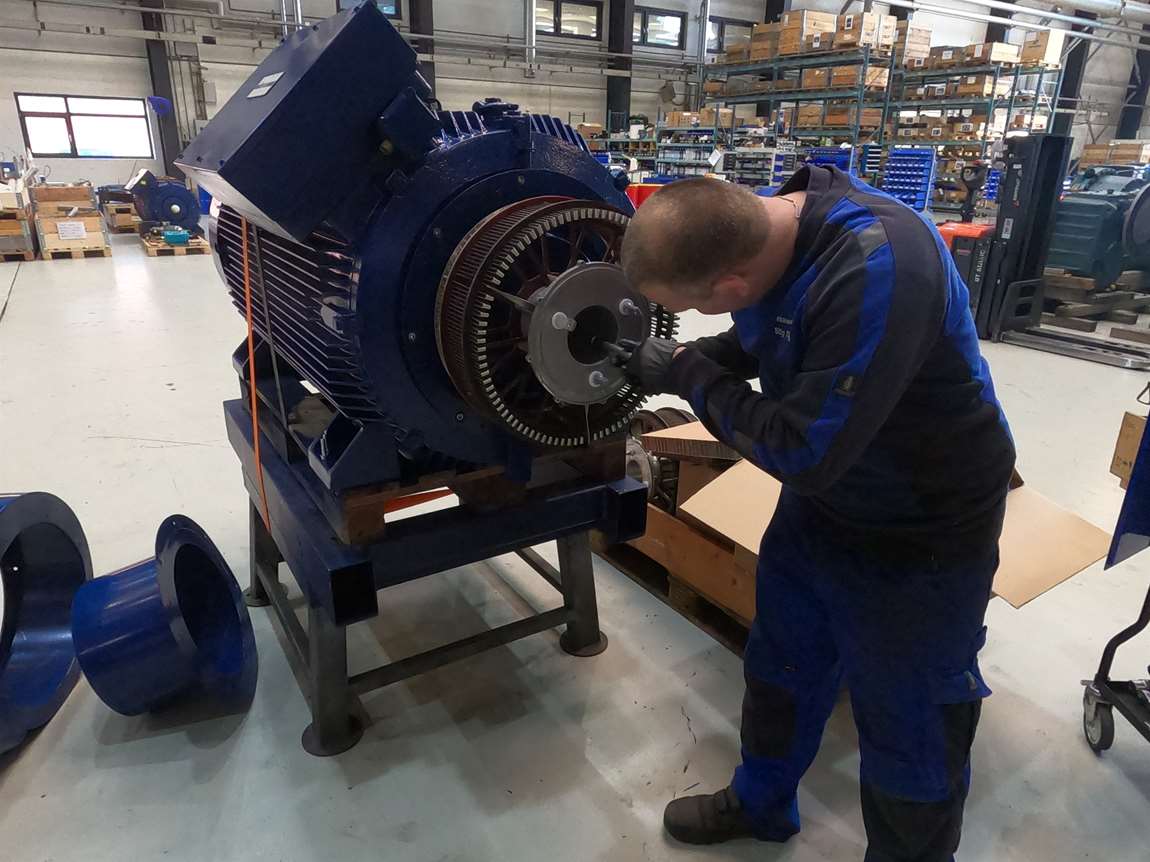 A WindTech technician repairing a generator