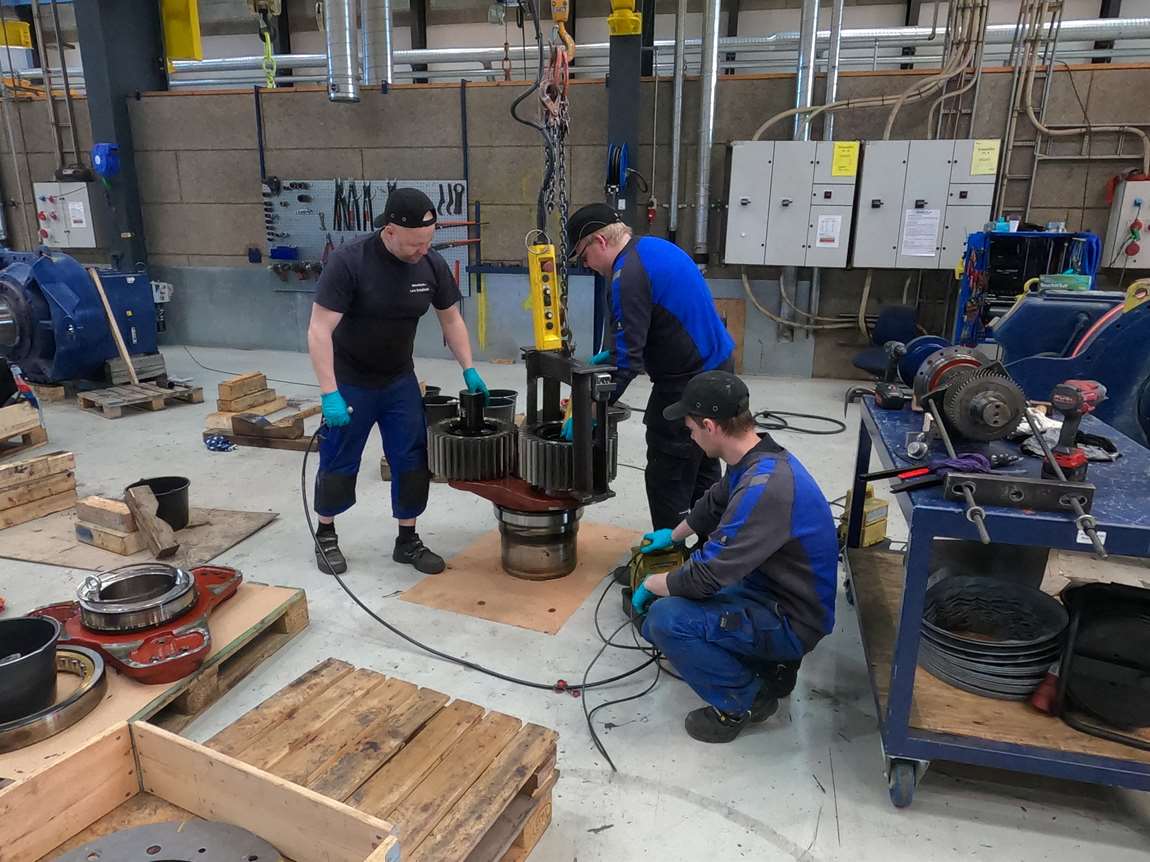 WindTech technicians repairing a wind turbine component